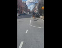 Guy rides cart like scooter down street