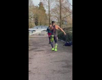 Man green black leggings dance between shrubs