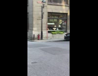 Girl sits side building guy lays street