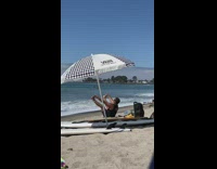 Man sit raise and hold feet beach