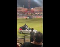 Horse riding car at stadium field 