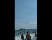 Plane flew upside down position with another plane at the beach