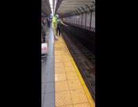 Yellow shirt guy dropped object subway tracks 