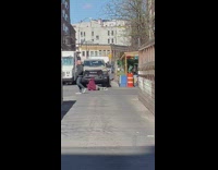Guy lying down in alley blocking pickup truck