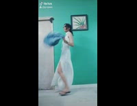 Woman does chores in nice clothes