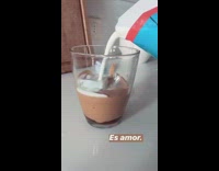 Milk poured into dalgona coffee cup