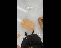 Employee unboxing rubber chicken squeeze toy