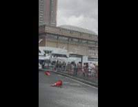 People walk near boat during storm 