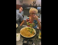 Chef pretends to splash sauce at elderly woman 