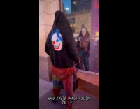 Shirtless clown flex chest in front of window