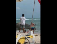 Guy pretends to drag girl in ocean 