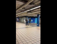 Man dance to woman singing at station