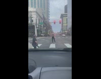 Woman kicks straight upwards on the pedestrian lane