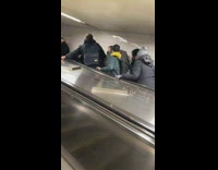 2 people roll down escalator 