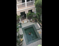 Guy middle of small pool hotel morning