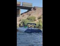 Man shirtless USA Flag shorts dance on boat