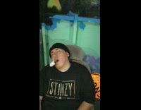 Friends slap sleeping guy in black beanie and stiiizy shirt until he wakes up