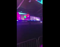 Man dances on stage with the same outfit as videographer