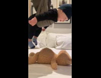 Baby carried with towel pick up teddy bear