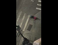 Guy lays on sidewalk at night