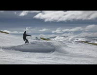 Skier frontflips off ramp and lands on back, red skis