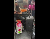 Woman Plays Music on Big Speaker 