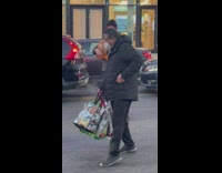 Guitarist tries to kick pedestrian in middle of street 