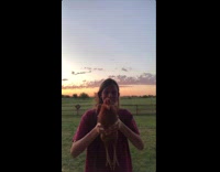 Girl holds moves brown chicken gyroscopic head