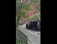 Guy swings arms next to car 