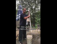 Man use pole strike laundry in bucket