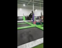 Guy does flips across trampoline park 