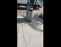 Pink heels are stuck to broken payphone 