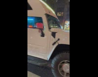 Giant party hummer limousine waiting at the stoplight 
