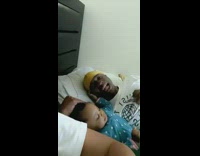 Dad and baby girl sing in bed