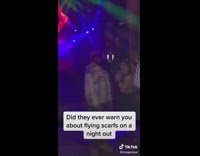 Girl swings scarf in club hits guy