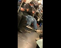 Man sit on train floor put on socks