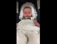 Baby closes eyes with mouth curled 