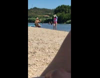 Woman in pink bikini with blue polo poses at the beach