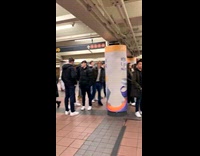 Woman sings at subway while people watches