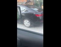 White parked car with its tires stolen