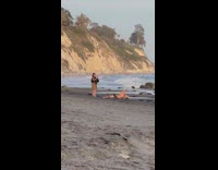 Girl yellow skirt lay stretch arms beach