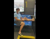 Guy one leg on blue seat train