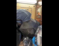 Fort built in train with bags and umbrellas