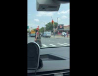 Guy dressed as clown cross the street