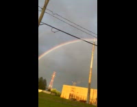 Full arch twinned ring rainbow on sunset
