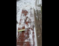 Submitter uses mop scrapes snow on bricks