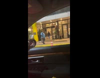 Man walks with striped tail behind him