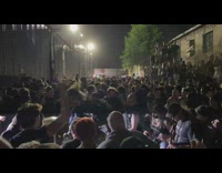 Crowd of people have mosh pit to metal band 