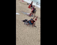 Woman twerk dance near kid at beach