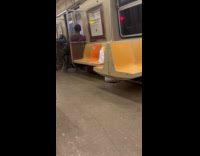 Man rides subway scratches back on handrail